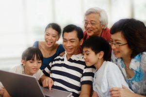 Intergenerational family looking at laptop together