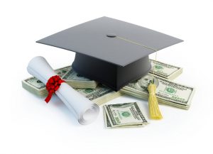 Graduation cap and diploma sitting on money 