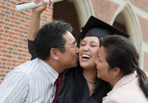 Asian student with parents at graduation