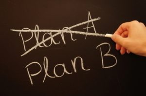 Plan A and Plan B written on a chalk board with Plan A crossed out