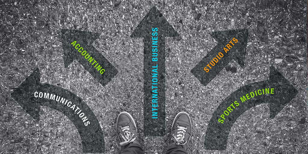 Student standing at several arrows pointing in different directions
